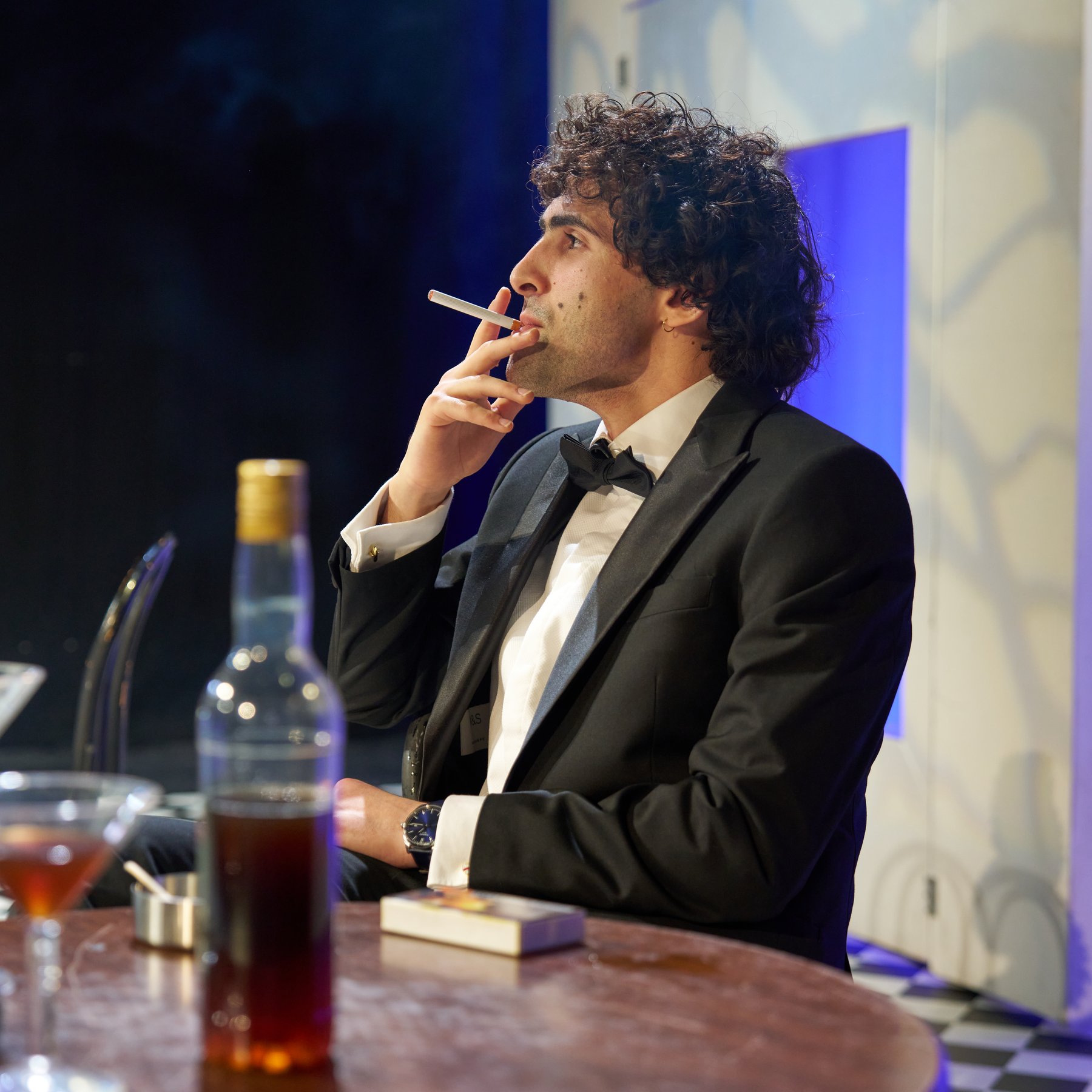 Leo Morad on stage at a bar, Private Lives